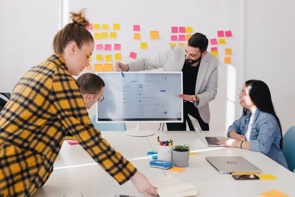 Team collaborating around a digital screen during a strategy planning session in a modern office